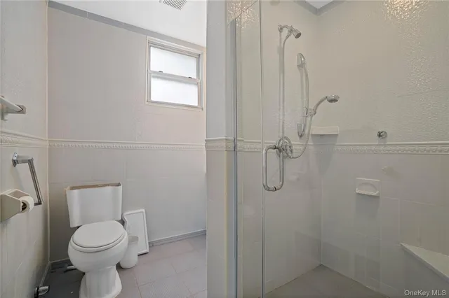 a bathroom with a toilet sink and shower