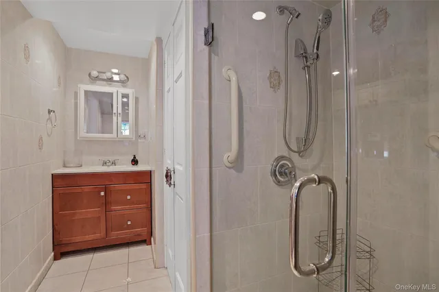 a bathroom with a shower a sink and mirror