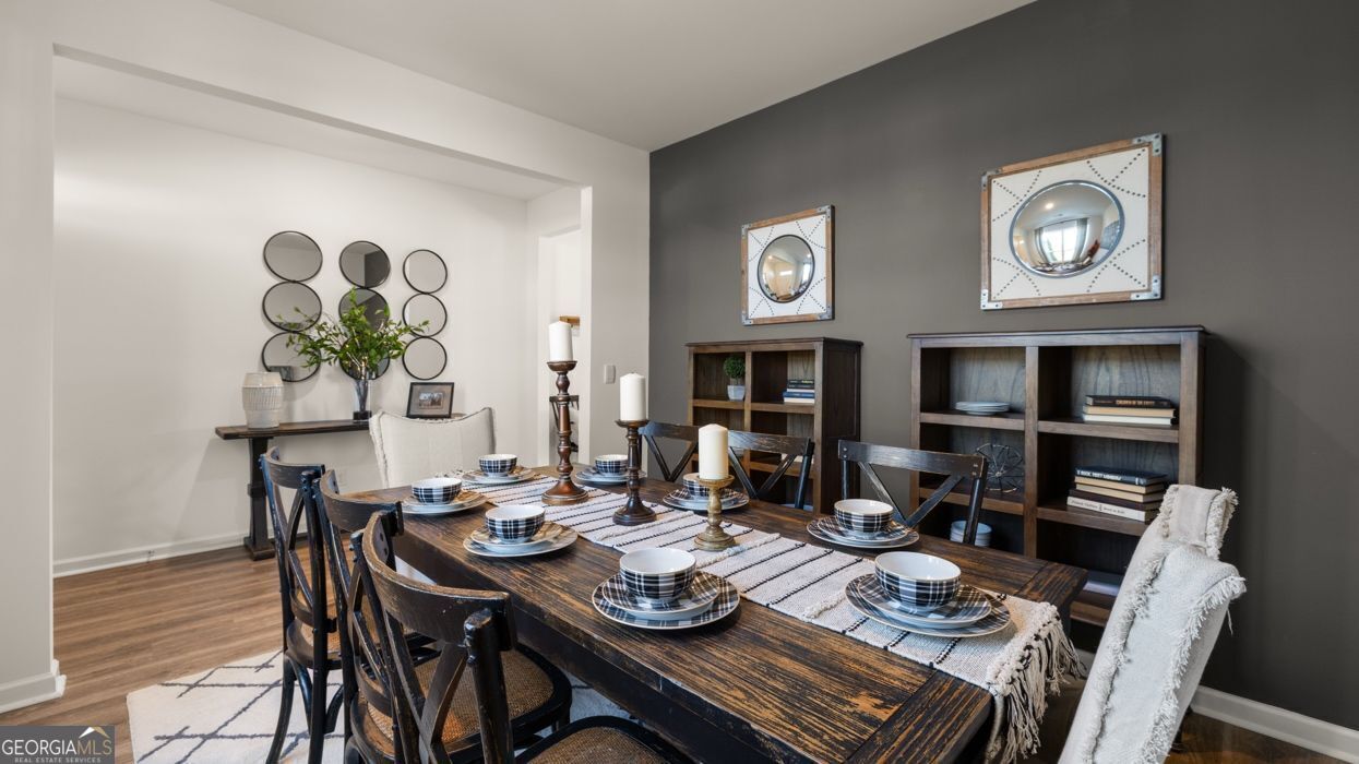 617 Lobelia Way Locust Grove, GA 30248 - Photo 18 of 44 a view of a dining room with furniture wooden floor and a rug