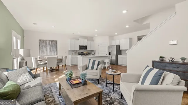 a living room with furniture wooden floor and a potted plant