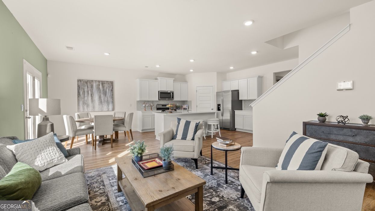 617 Lobelia Way Locust Grove, GA 30248 - Photo 19 of 44 a living room with furniture and kitchen view