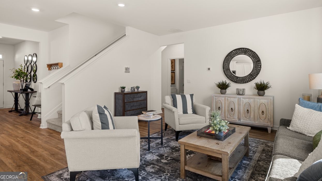 617 Lobelia Way Locust Grove, GA 30248 - Photo 21 of 44 a living room with furniture and a mirror