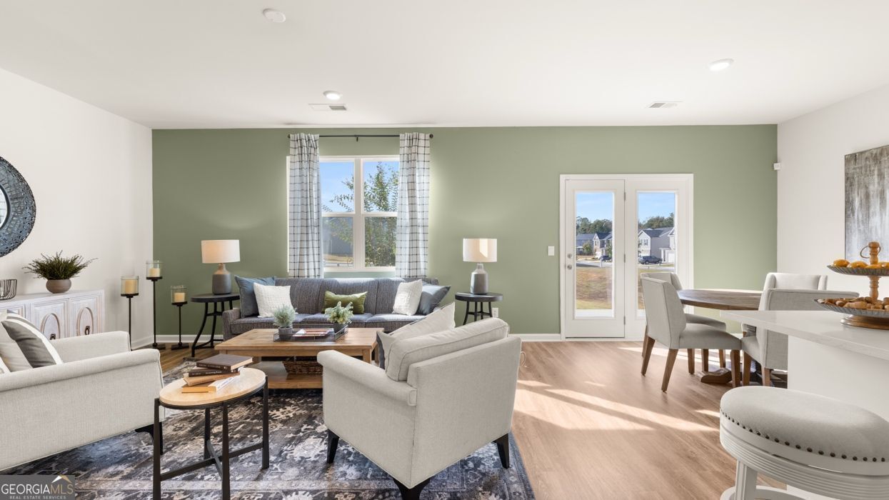 617 Lobelia Way Locust Grove, GA 30248 - Photo 22 of 44 a living room with furniture and a large window