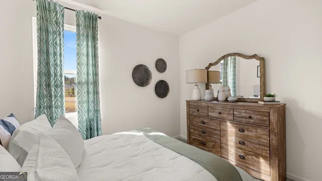 a bedroom with a bed and a painting on the wall