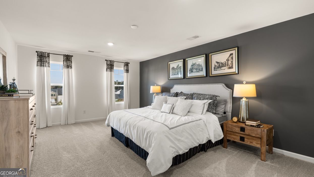 617 Lobelia Way Locust Grove, GA 30248 - Photo 33 of 44 a bedroom with a bed and a night stand