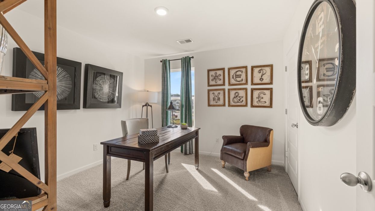 617 Lobelia Way Locust Grove, GA 30248 - Photo 38 of 44 a living room with furniture a wall paintings a wall and a window