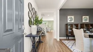 a view of a dining room with furniture and a floor to ceiling window