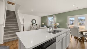 617 Lobelia Way Locust Grove, GA 30248 - Photo 43 of 44 a kitchen with a sink and a refrigerator