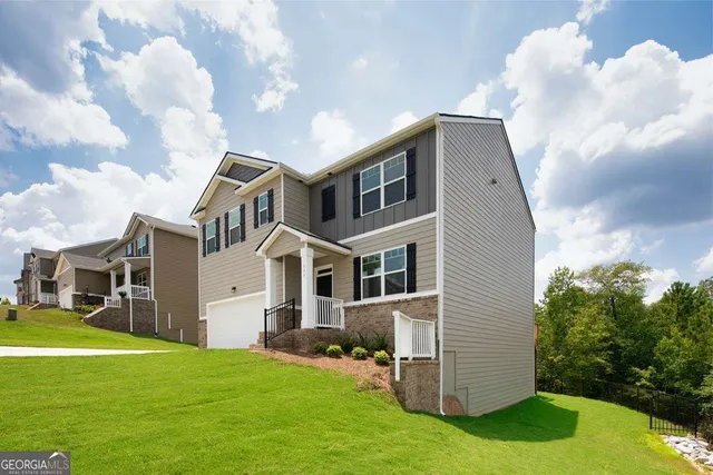 a front view of a house with a yard