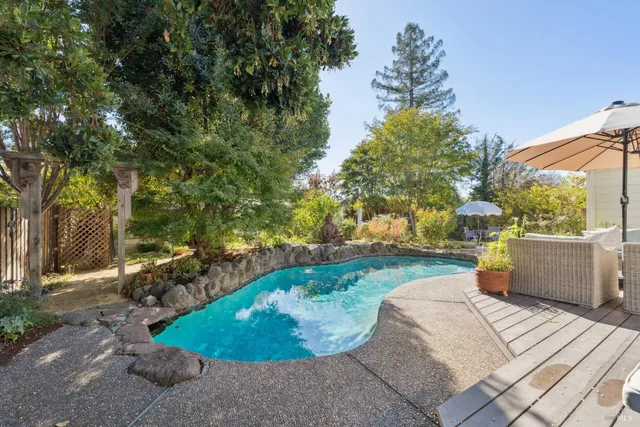 a view of garden with flowers and trees