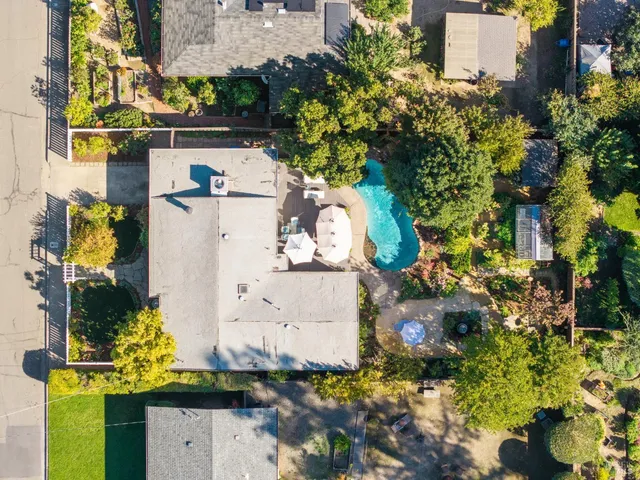 an aerial view of a house with a yard and garden