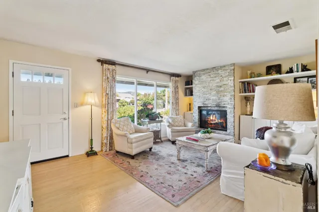 a living room with furniture and a fireplace