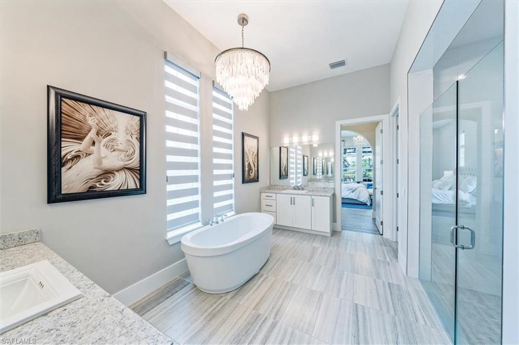 3181 Cullowee Lane Naples, FL 34114 - Photo 20 of 43 a large room with wooden floor and windows