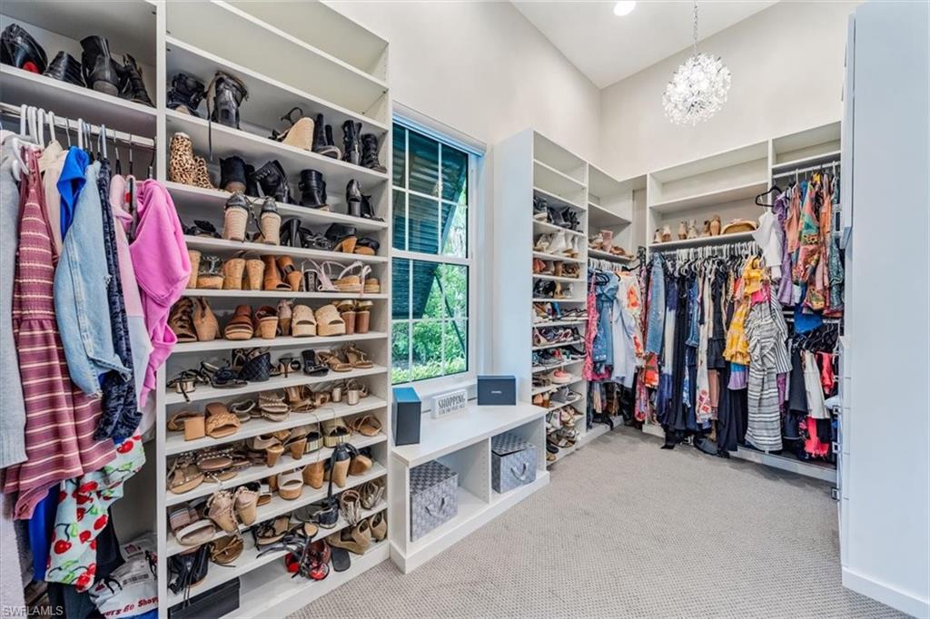 3181 Cullowee Lane Naples, FL 34114 - Photo 22 of 43 a view of walk in closet with clothes and shoes