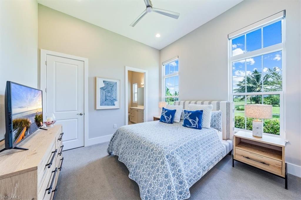 3181 Cullowee Lane Naples, FL 34114 - Photo 23 of 43 a bedroom with a bed and a tv