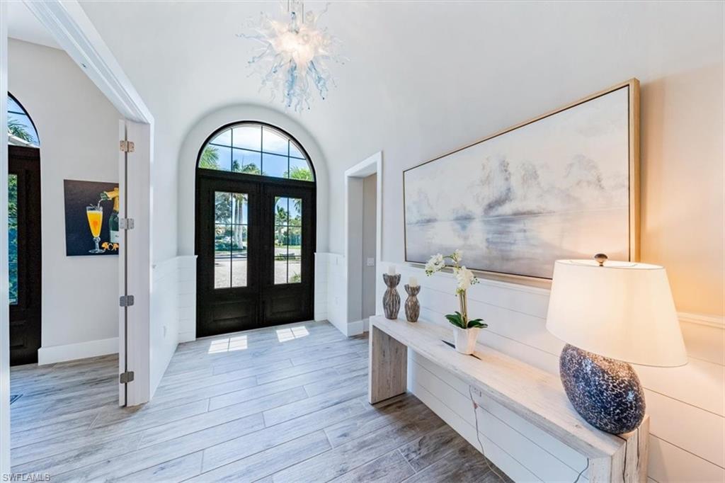 3181 Cullowee Lane Naples, FL 34114 - Photo 3 of 43 a large living room with a large bed and a window