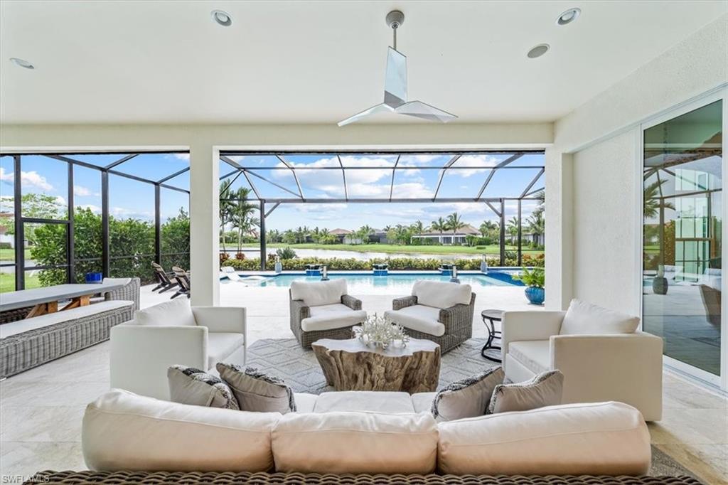 3181 Cullowee Lane Naples, FL 34114 - Photo 31 of 43 a living room with furniture and a large window