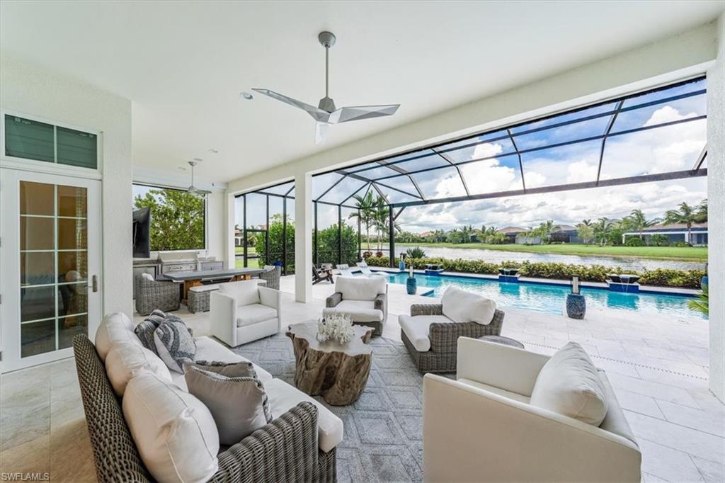 3181 Cullowee Lane Naples, FL 34114 - Photo 33 of 43 a living room with furniture tv and a large window