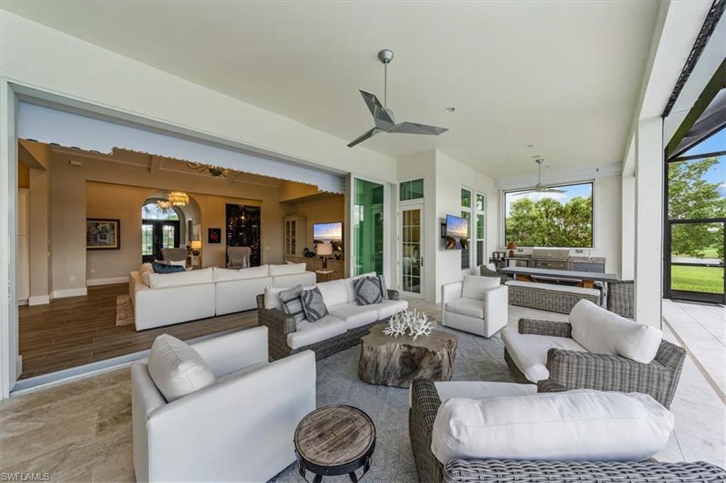 3181 Cullowee Lane Naples, FL 34114 - Photo 34 of 43 a living room with furniture and a large window
