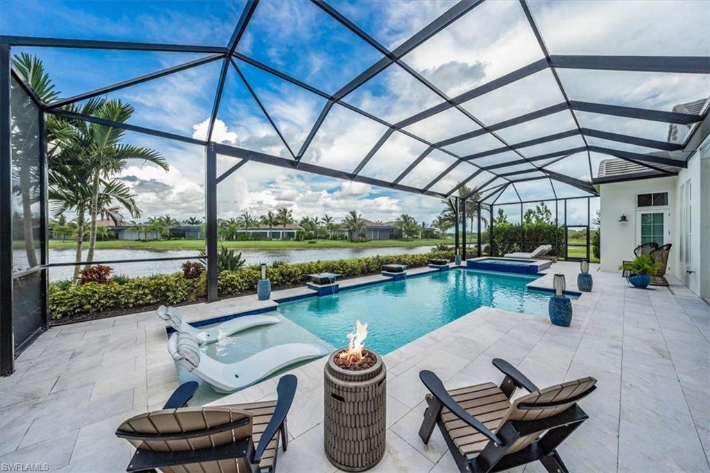 3181 Cullowee Lane Naples, FL 34114 - Photo 36 of 43 a view of a patio with a table chairs and a swimming pool