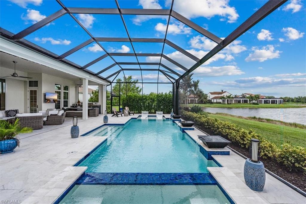 3181 Cullowee Lane Naples, FL 34114 - Photo 39 of 43 a swimming pool with lawn chairs and water view