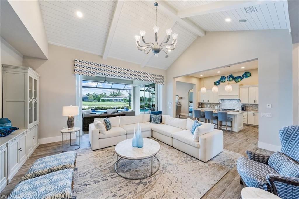 3181 Cullowee Lane Naples, FL 34114 - Photo 7 of 43 a living room with furniture chandelier and a large window