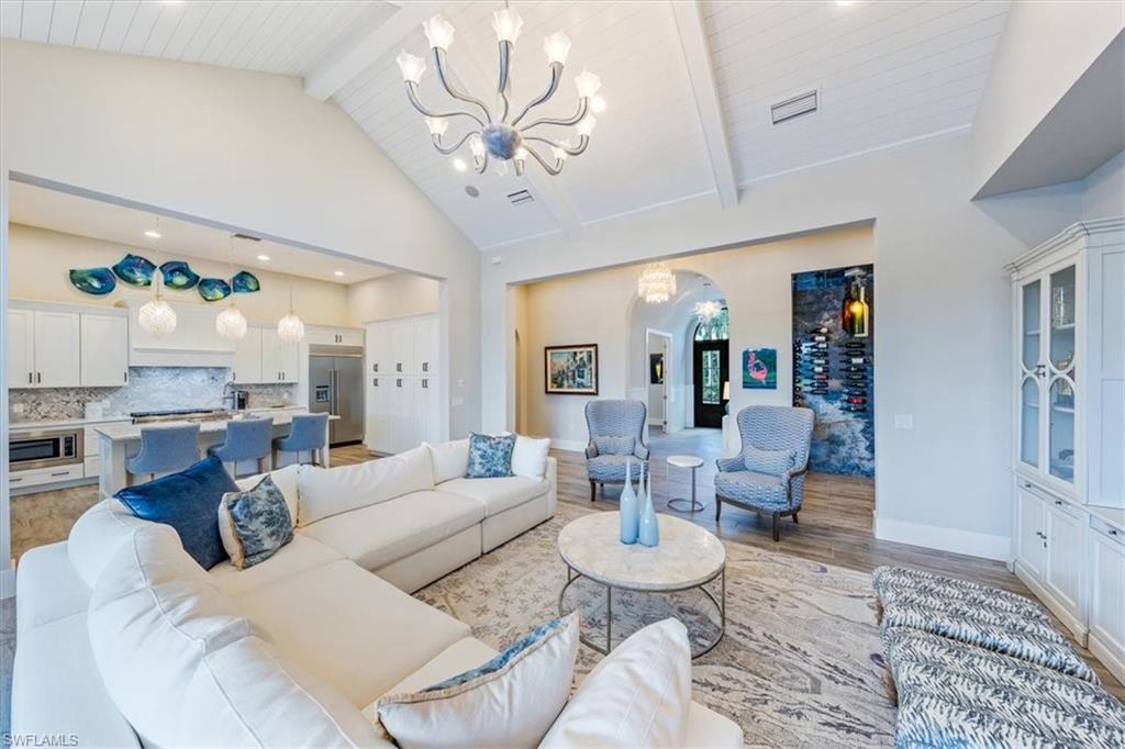 3181 Cullowee Lane Naples, FL 34114 - Photo 8 of 43 a living room with furniture and a chandelier