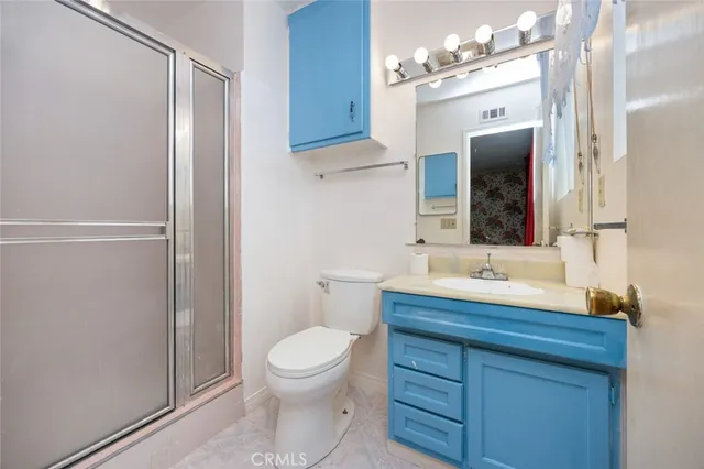 a bathroom with a toilet a sink and a mirror
