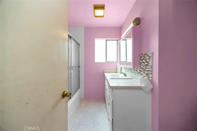 a bathroom with a sink a mirror and a bathtub