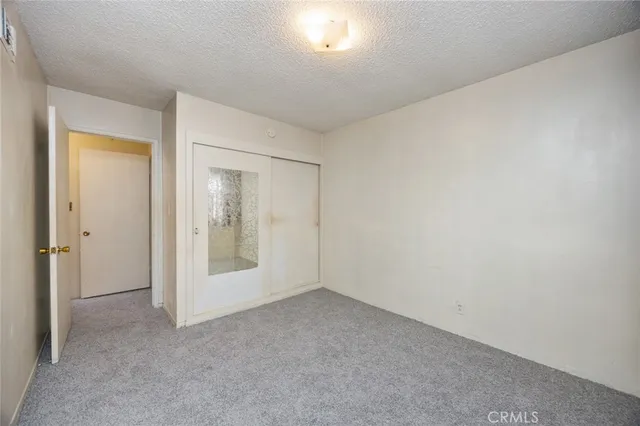 a view of an empty room and closet