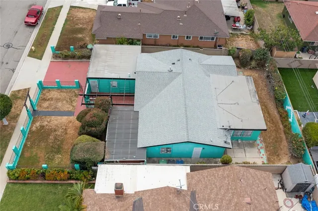 an aerial view of a house with a yard