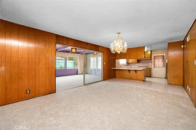 a large bedroom with a large bed and chandelier