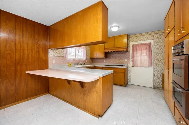 a kitchen with stainless steel appliances a sink and a refrigerator