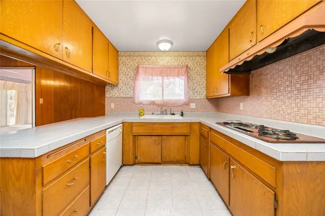 a kitchen with stainless steel appliances granite countertop a sink and a stove