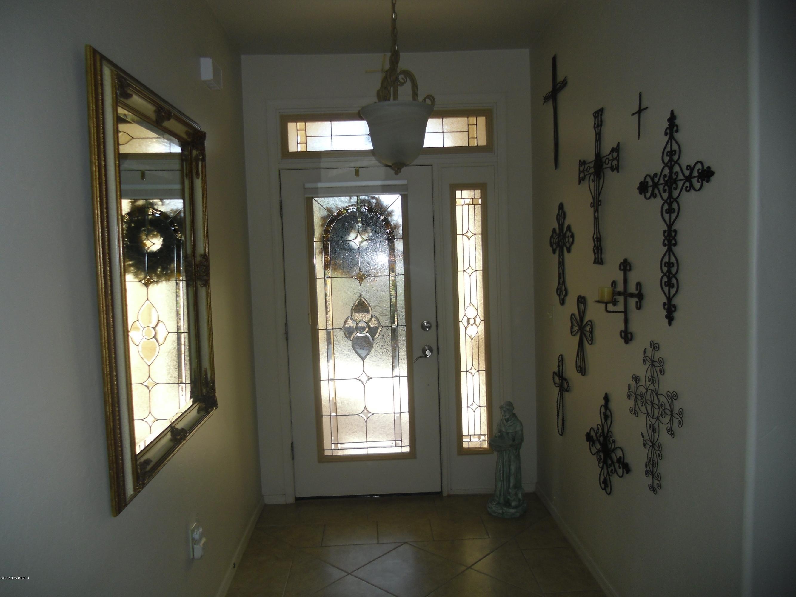 942 Via Puebla Rio Rico, AZ 85648 - Photo 27 of 73 a view of a hallway with windows and chandelier