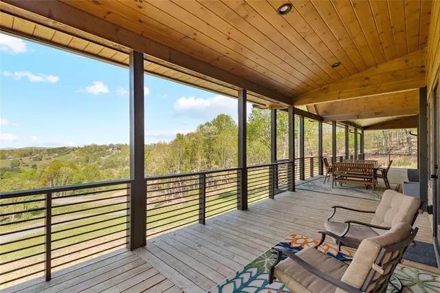 a kitchen with stainless steel appliances granite countertop a table chairs and a refrigerator