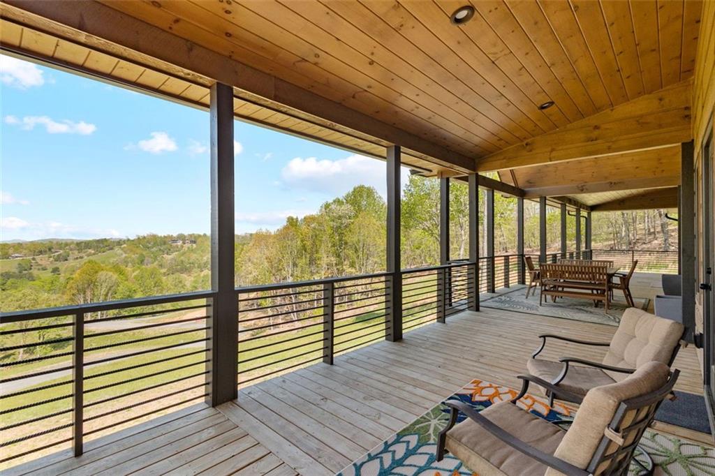 95 Upper Ridge Trail Blairsville, GA 30512 - Photo 17 of 71 a balcony with wooden floor outdoor seating and outdoor view