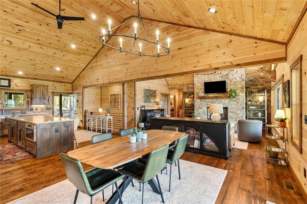 95 Upper Ridge Trail Blairsville, GA 30512 - Photo 29 of 71 a dining room with furniture a flat screen tv and wooden floor