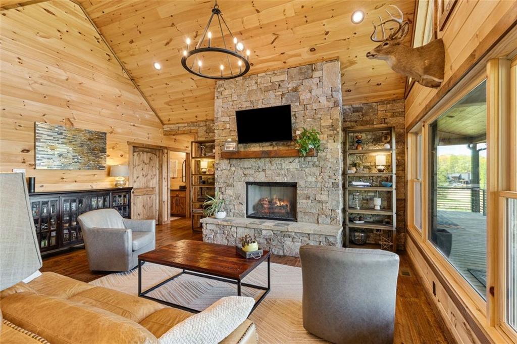 95 Upper Ridge Trail Blairsville, GA 30512 - Photo 33 of 71 a living room with furniture a flat screen tv and a fireplace