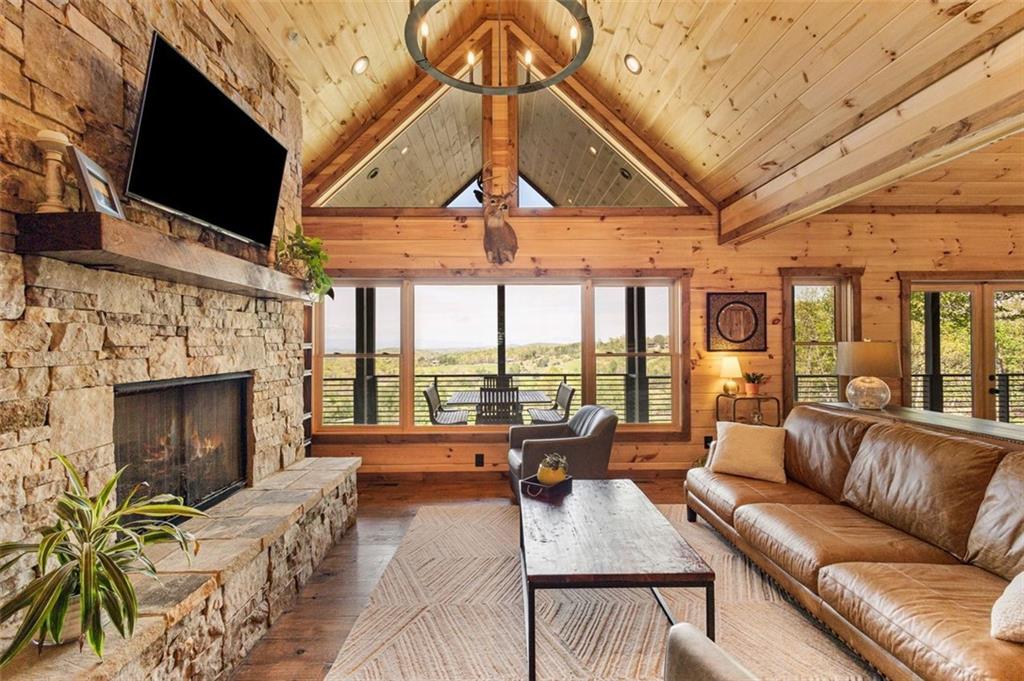 95 Upper Ridge Trail Blairsville, GA 30512 - Photo 35 of 71 a living room with furniture a fireplace and a flat screen tv