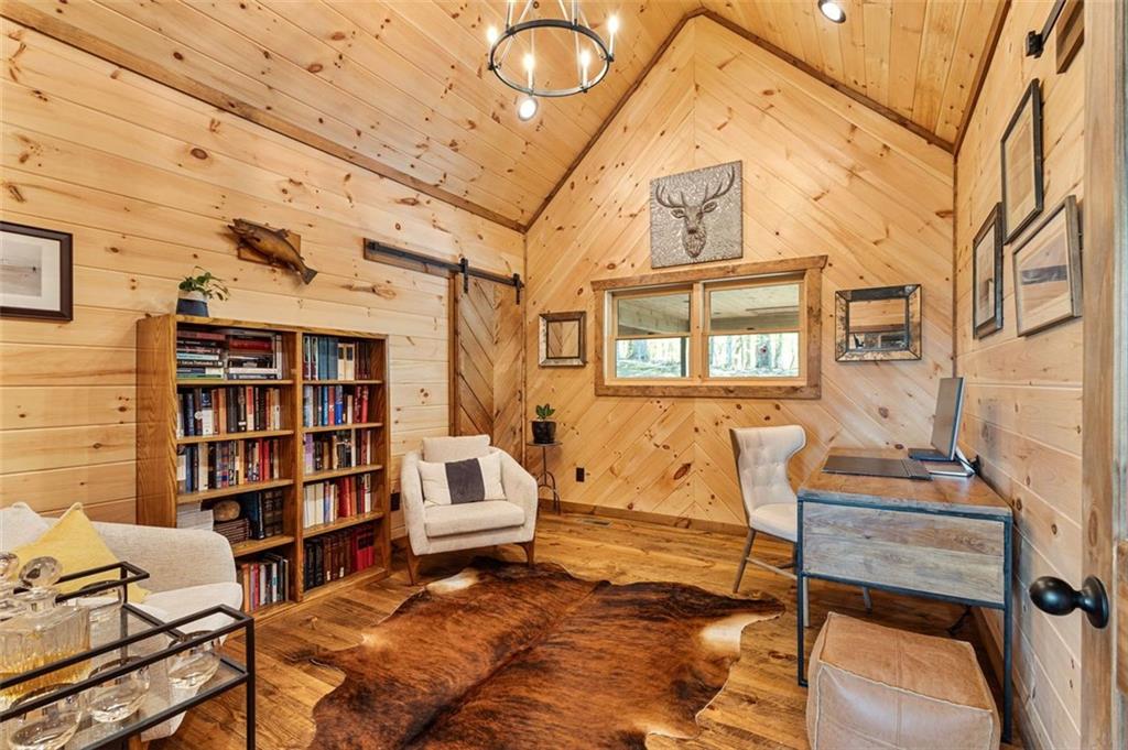 95 Upper Ridge Trail Blairsville, GA 30512 - Photo 43 of 71 a living room with furniture a rug and a bookshelf