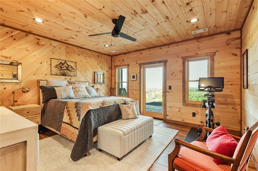 95 Upper Ridge Trail Blairsville, GA 30512 - Photo 52 of 71 a spacious bedroom with a bed a couch and ceiling fan