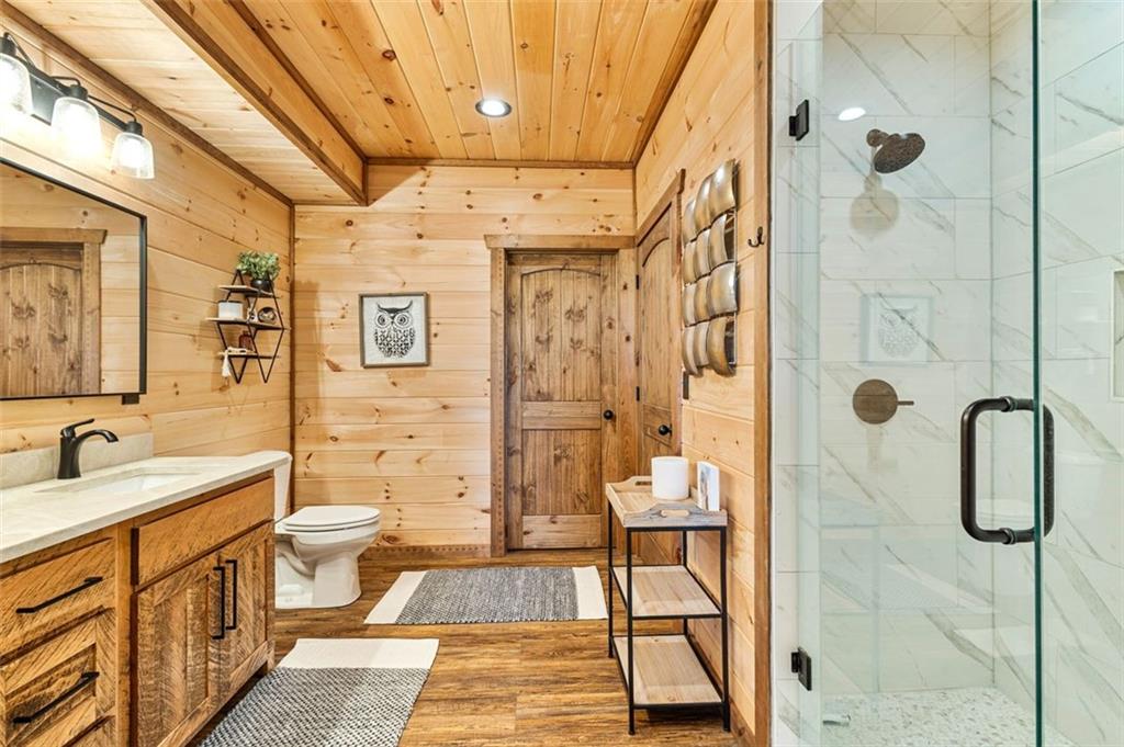95 Upper Ridge Trail Blairsville, GA 30512 - Photo 56 of 71 a bathroom with a double vanity sink toilet mirror and shower