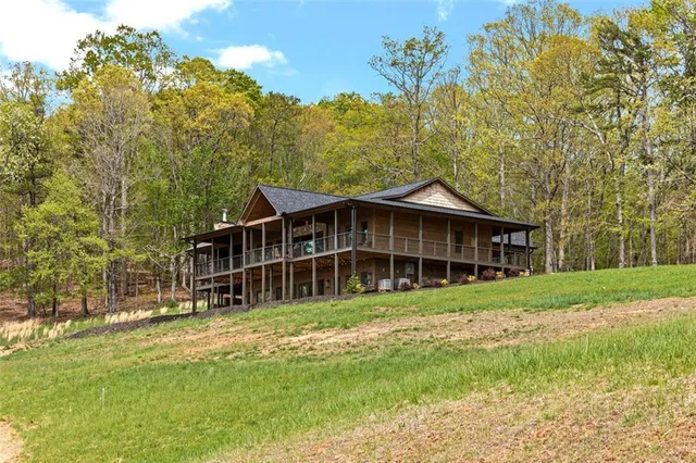 a view of a porch with a table and chairs