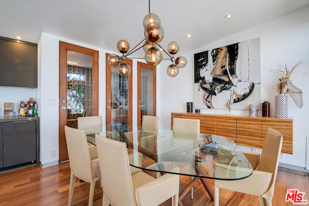 11458 Laurelcrest Road Studio City, CA 91604 - Photo 11 of 30 a view of a dining room with furniture a chandelier and wooden floor