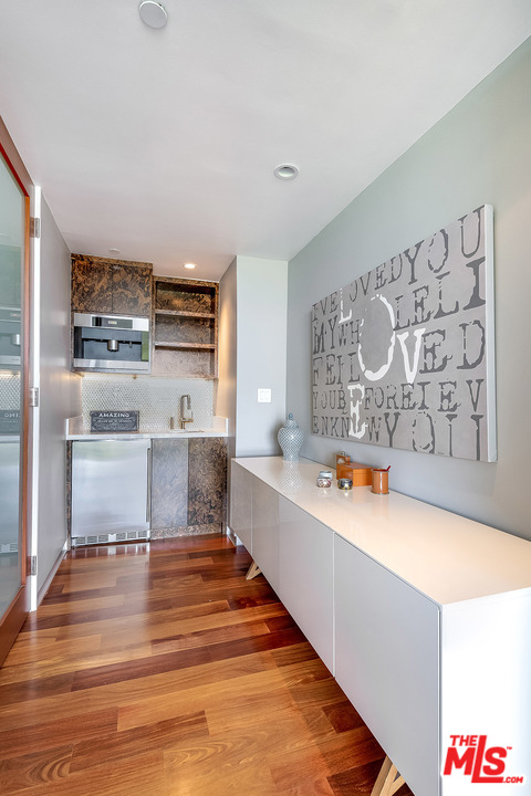 11458 Laurelcrest Road Studio City, CA 91604 - Photo 17 of 30 a large kitchen with stainless steel appliances wooden floor and a refrigerator
