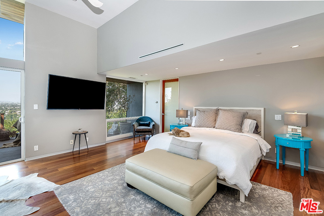 11458 Laurelcrest Road Studio City, CA 91604 - Photo 18 of 30 a spacious bedroom with a bed and a flat screen television