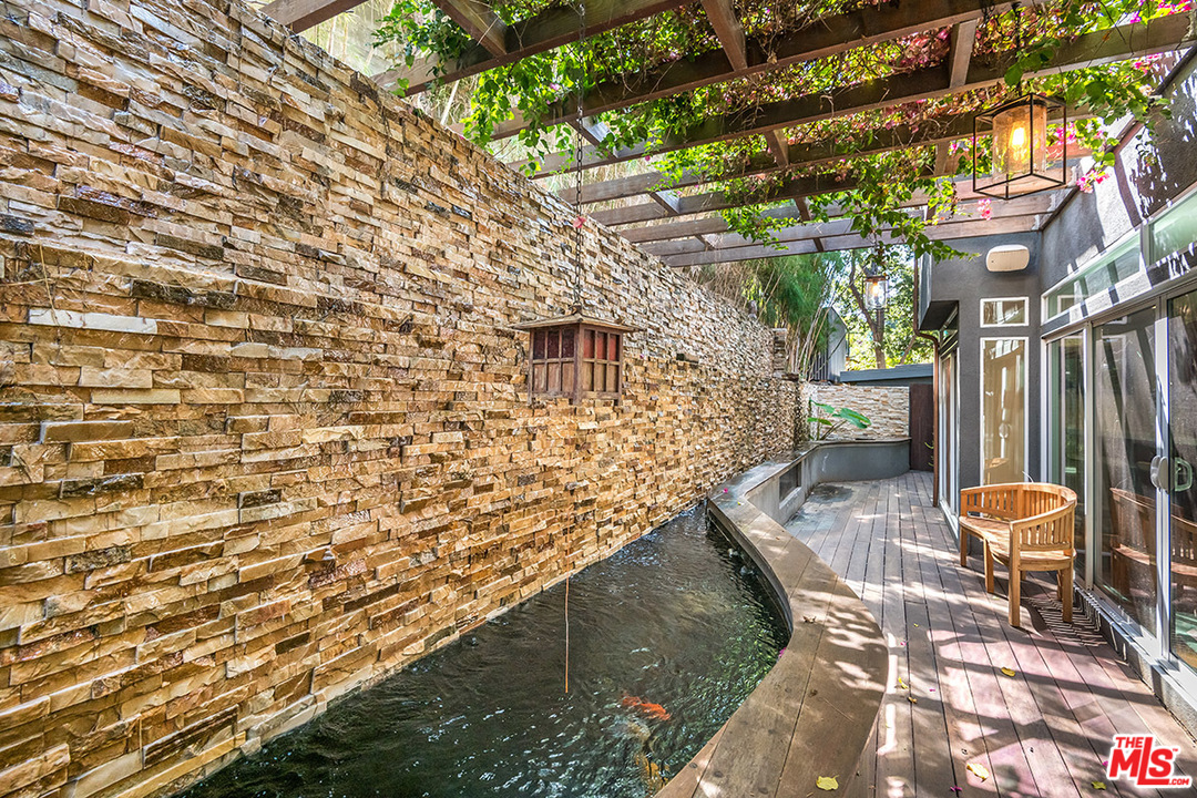 11458 Laurelcrest Road Studio City, CA 91604 - Photo 23 of 30 a balcony with wooden floor and outdoor seating
