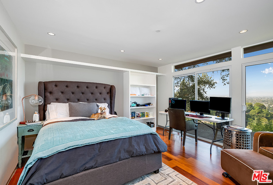 11458 Laurelcrest Road Studio City, CA 91604 - Photo 27 of 30 a bedroom with a bed and a flat screen tv