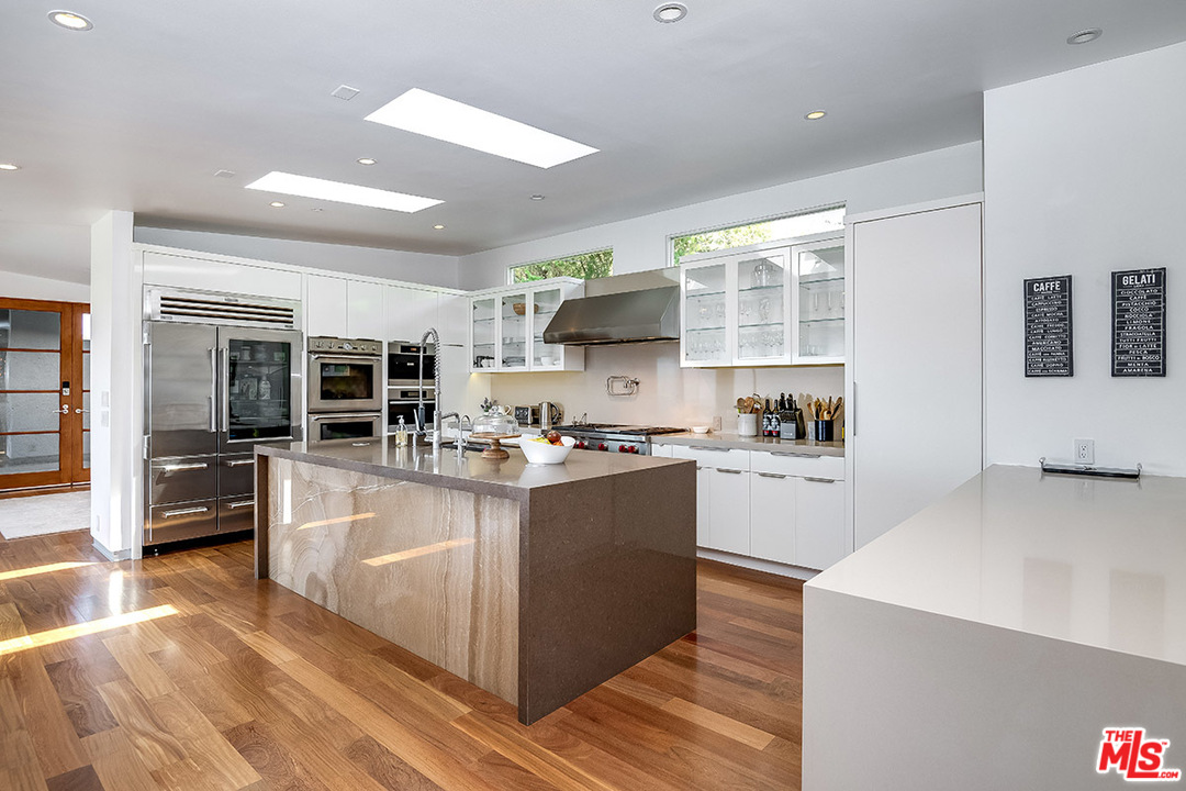 11458 Laurelcrest Road Studio City, CA 91604 - Photo 3 of 30 a large kitchen with stainless steel appliances granite countertop a large counter top and a stove top oven